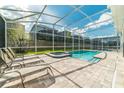 Enjoy this screened-in outdoor pool with a hot tub and ample seating for relaxation at 1673 Moon Valley Dr, Davenport, FL 33896