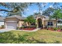 Lovely single-story home with a well-kept lawn and manicured landscaping elements at 1913 Lazy Oaks Loop, St Cloud, FL 34771