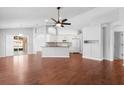 Open concept living room with hardwood floors that leads to a modern kitchen at 1960 Evard Ave, Deltona, FL 32725
