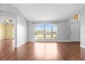 Bright living room with hardwood floors, large window, and neutral paint at 1960 Evard Ave, Deltona, FL 32725