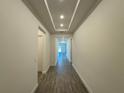 Entry hallway featuring tray ceiling, recessed lighting and wood look tile floors at 2013 Divot Dr, Daytona Beach, FL 32124