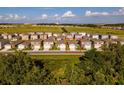 Aerial view of a neighborhood showcasing the home's location among similar residences and green spaces at 2464 Ribbon Fall Ave, Davenport, FL 33837