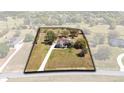 Expansive property with a well-maintained home, long driveway, and ample green space, as seen from an aerial perspective at 25249 Derby Dr, Sorrento, FL 32776
