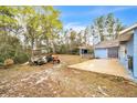 Spacious backyard featuring a covered patio area, a tractor and some other farm equipment at 2935 Apaloosa Trl, Deltona, FL 32738