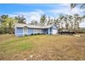 A single-story home with a well-maintained lawn and a driveway leading to an attached garage at 2935 Apaloosa Trl, Deltona, FL 32738