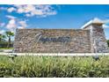 Tapestry community entrance with stone waterfall feature and lush landscaping, offering an upscale, welcoming environment at 3018 Jardin St, Kissimmee, FL 34741