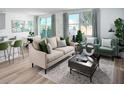 Cozy living room with neutral tones, plush seating, stylish decor, and plenty of natural light at 309 Castle Dr, Lake Alfred, FL 33850