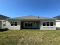 Spacious backyard featuring a covered patio and a well-maintained green lawn at 3108 Firethorn Cir, Daytona Beach, FL 32124
