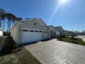 View of a charming single-story home with a two-car garage and a beautifully paved driveway at 3108 Firethorn Cir, Daytona Beach, FL 32124