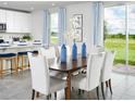 Elegant dining area with seating for six and sliding glass doors providing abundant natural light at 313 Castle Dr, Lake Alfred, FL 33850