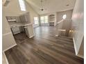 Open concept living space featuring vaulted ceilings and wood floors at 3291 Westchester Square Blvd # 203, Orlando, FL 32835