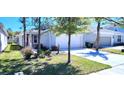 Inviting single-Gathering home featuring a two-car garage, landscaped lawn, and beautiful curb appeal at 3538 Treetop St, Deland, FL 32724