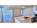 Open-concept kitchen and dining area with stainless steel appliances and access to the backyard at 3538 Treetop St, Deland, FL 32724