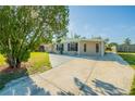Single-story home with a spacious driveway and well-manicured front lawn at 4192 Gallimore St, Orlando, FL 32811