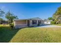 Well-maintained single-story home on a sunny day with a spacious green lawn at 4192 Gallimore St, Orlando, FL 32811