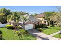 Charming single-story home with a well-manicured lawn, paver driveway, and attached two-car garage at 5108 Legacy Oaks Dr, Orlando, FL 32839