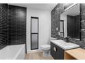 Modern bathroom with stylish black tile, sleek fixtures, and minimalist design at 607 Dunblane Dr, Winter Park, FL 32792