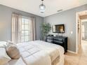 Comfortable main bedroom with gray walls, a large window and neutral accents at 619 Lake Marion Golf Resort, Kissimmee, FL 34759