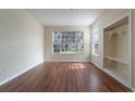 Bright living room featuring beautiful hardwood floors, large windows, and a closet for storage at 9117 Lee Vista Blvd # 603, Orlando, FL 32829
