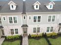 Beautiful aerial view showcasing a stylish townhome with manicured landscaping and inviting entrance at 936 Wild Date Ln, Lake Mary, FL 32746