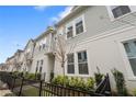 Charming townhomes with grey siding and white trim feature neat landscaping and black metal fences at 936 Wild Date Ln, Lake Mary, FL 32746