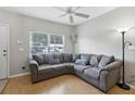 Comfortable living room with a large sectional sofa, neutral walls, and a bright window at 104 Wilton Cir, Sanford, FL 32773
