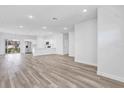 Open-concept living area with hardwood floors, bright white walls and natural light from the sliding glass door at 13594 Sw 40 Cir, Ocala, FL 34473