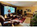 Spacious living room with ample seating, a TV, and natural light, perfect for relaxation and entertaining at 1361 Markham Woods Rd, Longwood, FL 32779