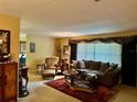 Comfortable living room featuring a large window, plush seating, and a cozy ambiance at 1361 Markham Woods Rd, Longwood, FL 32779