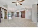Open-concept living room featuring tile flooring, chandelier lighting, and access to outdoor spaces and bedrooms at 14772 Eagles Crossing Dr, Orlando, FL 32837