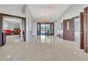 Spacious living room with tile floors, chandelier lighting, and doors leading to the outdoor space at 14772 Eagles Crossing Dr, Orlando, FL 32837