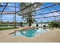 Screened in pool overlooking a tranquil lake, perfect for relaxation and enjoying the outdoors at 14772 Eagles Crossing Dr, Orlando, FL 32837