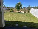 Picture of a large backyard with green lawn and a view of other homes in the neighborhood at 179 Blue Cypress Dr, Davenport, FL 33837