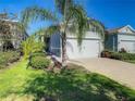 Exterior showcases lush lawn and landscaping with a paved driveway leading to the home's attached garage at 1830 Estuary Ln, Kissimmee, FL 34747