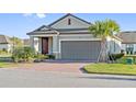 Lovely single-story home with a brick driveway, two-car garage, and well-maintained landscaping at 188 Olympus Way, Kissimmee, FL 34759
