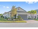 Attractive single-story home with a brick driveway, two-car garage, and mature trees at 188 Olympus Way, Kissimmee, FL 34759