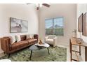 Bright living room with modern decor, high ceilings, tile flooring, contemporary furnishings, and large window with blinds at 2015 Sandy Garden Ln, Winter Garden, FL 34787