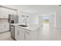 Kitchen island with stainless steel dishwasher and sink that opens to the living area at 2098 Rosewood Dr, Bartow, FL 33830