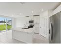 Bright kitchen with stainless steel appliances, island and white cabinetry at 2105 Rosewood Dr, Bartow, FL 33830
