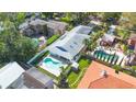 Aerial view of a home with a private pool, lush greenery, and neatly fenced yard providing a serene retreat at 250 Cortland Ave, Winter Park, FL 32789