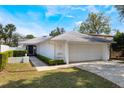 Charming single-story home featuring a well-maintained lawn, a two-car garage, and freshly manicured landscaping at 250 Cortland Ave, Winter Park, FL 32789