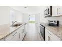 A sleek kitchen boasts granite countertops, stainless steel appliances, and an open concept layout at 2507 Linda Knoll Ln, Bartow, FL 33830