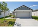 Inviting single-Gathering home with an attached two-car garage, well-manicured lawn, and modern architectural details at 2514 Linda Knoll Ln, Bartow, FL 33830