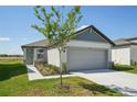 Charming single-Gathering home featuring a two-car garage, landscaped front yard, and neutral color palette at 2514 Linda Knoll Ln, Bartow, FL 33830