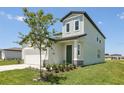 Well-maintained home featuring a manicured lawn, green door, and neutral-colored siding at 2515 Linda Knoll Ln, Bartow, FL 33830