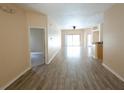 Bright living room featuring wood-look floors and sliding glass doors at 2788 Roccella Ct, Kissimmee, FL 34747