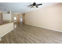 A spacious living room features wood-look floors, a ceiling fan, and neutral paint at 2788 Roccella Ct, Kissimmee, FL 34747