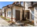 Charming townhome entrance with landscaped garden, modern exterior light fixture, and wood accents at 2900 S Semoran Blvd # 4, Orlando, FL 32822