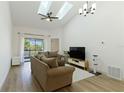 Bright living room featuring vaulted ceilings, skylights, modern fan and neutral decor at 2900 S Semoran Blvd # 4, Orlando, FL 32822