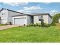 Beautiful single-Gathering home with brick-paved driveway, well-kept lawn, and stone facade at 2948 Wild Olive Dr, St Cloud, FL 34772